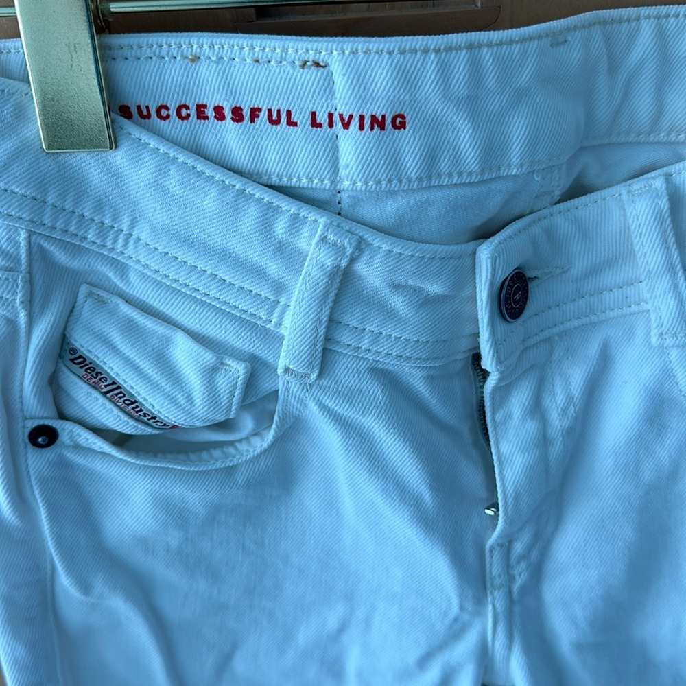 White denim Diesel jeans.